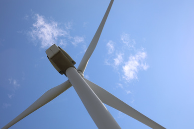 Photo of Wind turbine against beautiful blue sky, low angle view. Alternative energy source