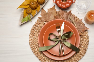 Beautiful place setting with autumn decor on white wooden table, flat lay