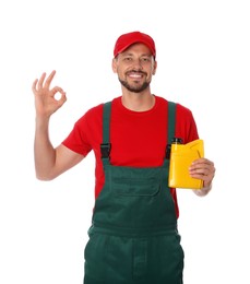 Man holding yellow container of motor oil and showing OK gesture on white background