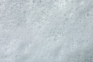 Photo of Fluffy soap foam as background, top view
