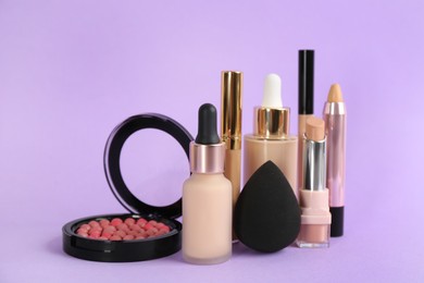 Foundation makeup products on violet background. Decorative cosmetics
