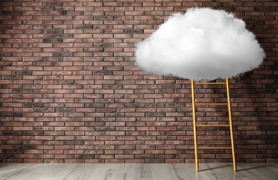 Wooden ladder with cloud near brick wall, space for text . Conceptual design 