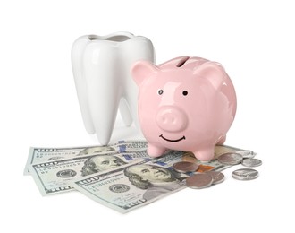 Ceramic model of tooth, piggy bank and money on white background. Expensive treatment