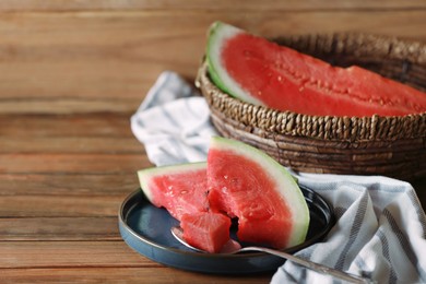 Fresh juicy watermelon and spoon on wooden table. Space for text