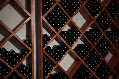 Many bottles of wine on shelves in cellar