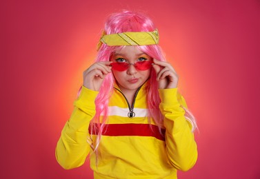Cute indie girl with sunglasses on bright pink background