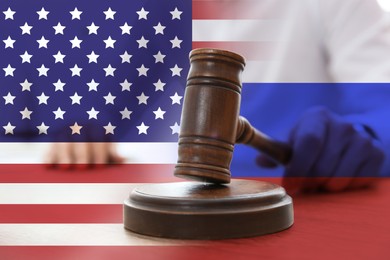 Economic sanctions against Russia because of invasion in Ukraine. Judge with gavel at table, American and Russian flags. Multiple exposure