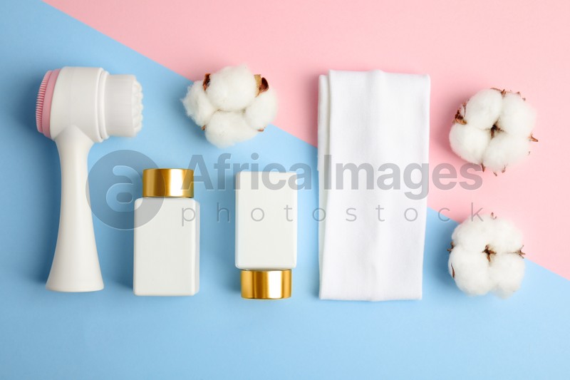 Photo of Flat lay composition with face cleansing brush on color background. Cosmetics tool
