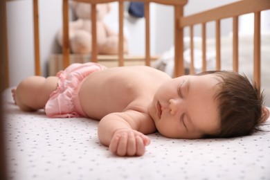 Photo of Cute little baby sleeping in crib at home. Bedtime