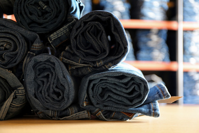 Rolled modern jeans on display in shop, closeup