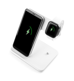 Mobile phone and smartwatch charging with wireless pad isolated on white