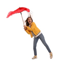 Emotional woman with umbrella caught in gust of wind on white background