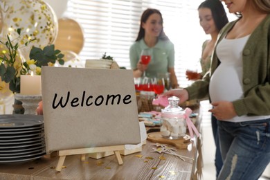 Pregnant woman and her friends taking delicious treats at baby shower party, closeup