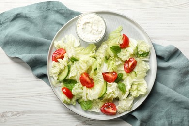 Photo of Delicious salad with Chinese cabbage, tomatoes, cucumber and dressing on white wooden table, top view