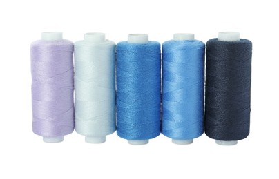 Set of different colorful sewing threads on white background