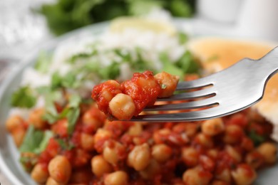 Photo of Fork with delicious chickpea curry, closeup view