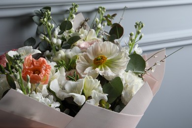 Photo of Bouquet of beautiful flowers on grey background, closeup