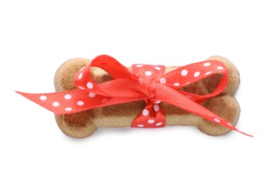 Bone shaped dog cookie with red bow isolated on white, top view