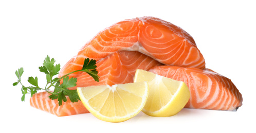Fresh raw salmon with parsley and lemon on white background. Fish delicacy