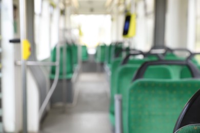 Blurred view of public transport interior with comfortable green seats