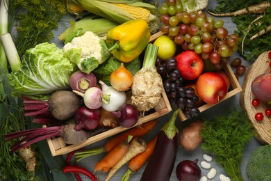 Photo of Different fresh vegetables and fruits on grey wooden table, flat lay. Farmer harvesting