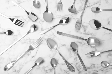 Set of new luxury cutlery on marble table, flat lay