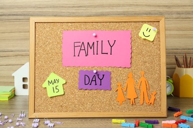 Happy Family Day. Composition with cork board and stationery on wooden table