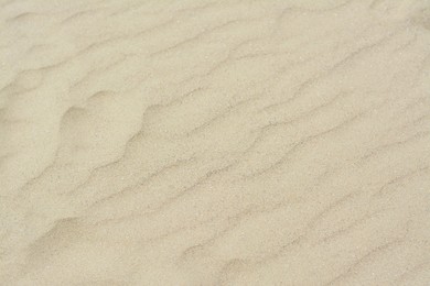 Dry beach sand with wave pattern as background