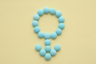 Male sign made of blue pills on beige background, flat lay. Potency problems