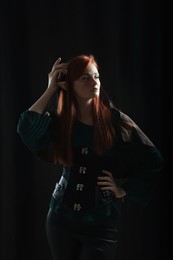 Beautiful redhead elf girl on black background