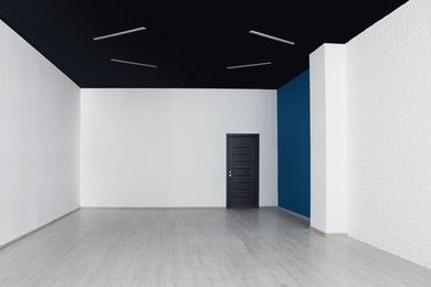 Empty office room with black ceiling and door. Interior design