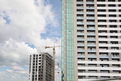 Construction site with tower crane near unfinished buildings