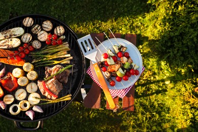 Cooked food products and grill barbecue outdoors, top view