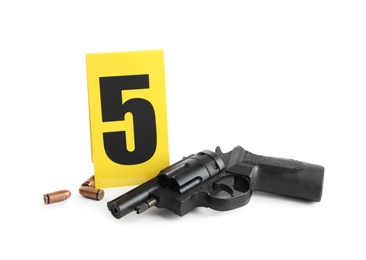 Gun, bullets and crime scene marker with number five isolated on white