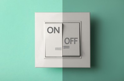 Image of Turned ON and OFF light switch on turquoise background