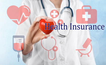 Phrase Health Insurance, icons and doctor with heart model on light background