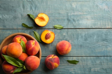 Fresh sweet peaches on wooden table, flat lay. Space for text