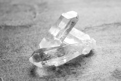 Photo of Beautiful rock crystal gemstones on grey table