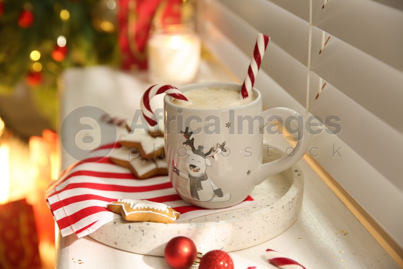 Composition with cup of hot drink on windowsill