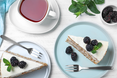 Tasty cake with berries on white wooden table, flat lay