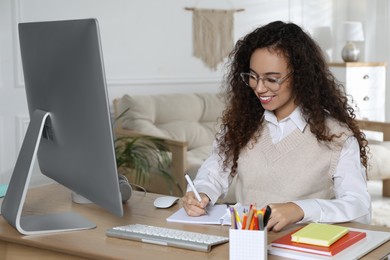 African American woman using modern computer for studying at home. Distance learning