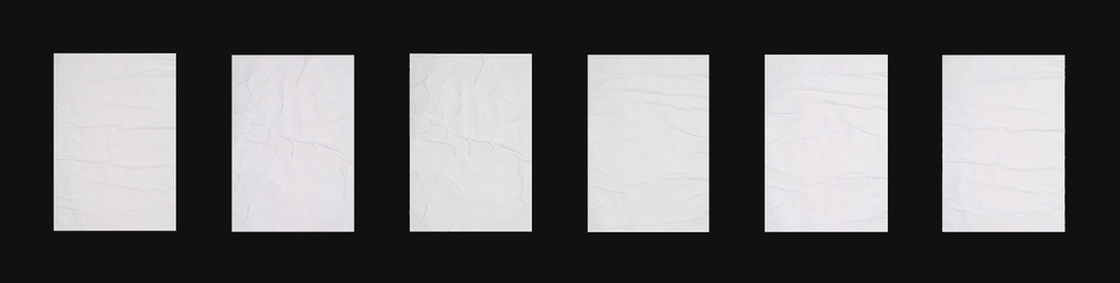 Collection of creased blank posters on black background. Banner design