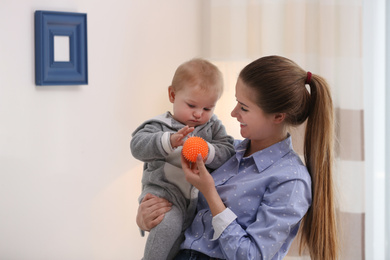 Teen nanny with cute little baby at home