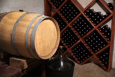 Large wooden barrel on table in wine cellar