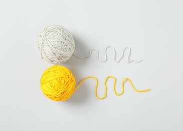 Soft colorful woolen yarns on white background, flat lay