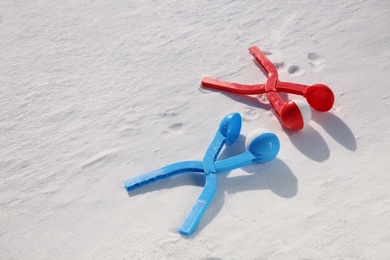 Snowballs and plastic tools outdoors on winter day