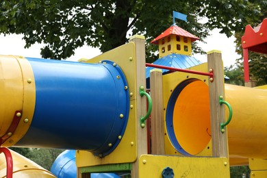 Children's playground with bright slides on summer day