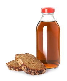 Photo of Glass bottle of delicious kvass and bread slices on white background. Refreshing drink