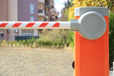 Closed automatic boom barrier on sunny day outdoors, closeup
