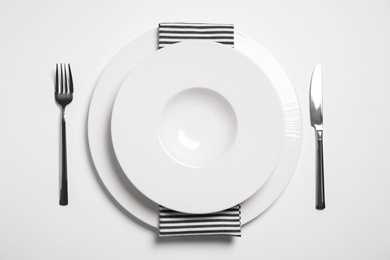 Stylish table setting on white background, top view